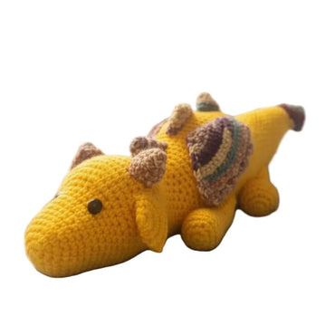 Yellow dragon toy with a striped wings on a white background