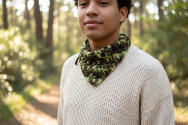 Person wearing a camouflage bandana in a forest setting