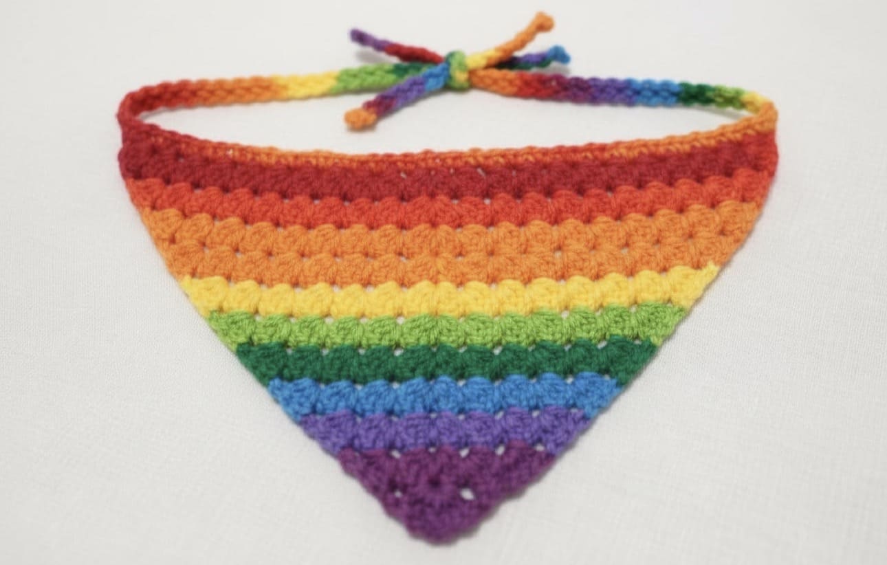Crocheted rainbow bandana on a white background