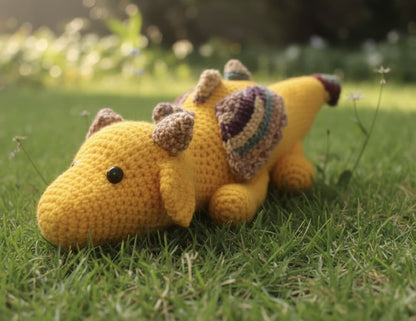Yellow stuffed animal with a hat on grass